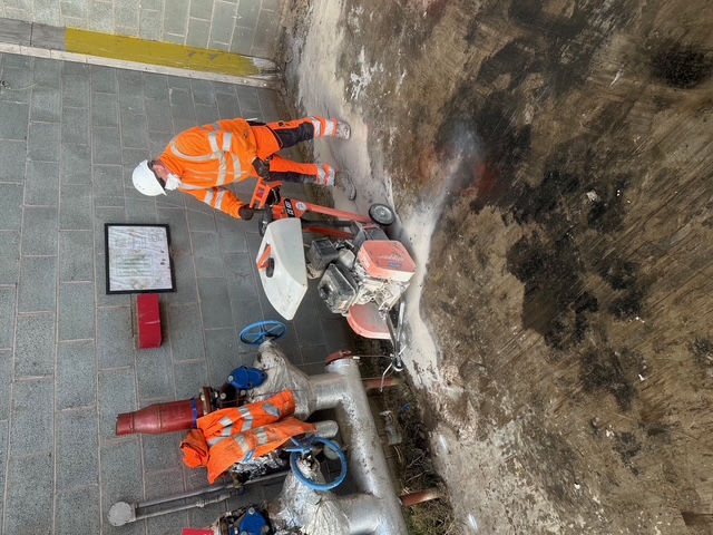 Construction worker operating a floor saw for site preparation